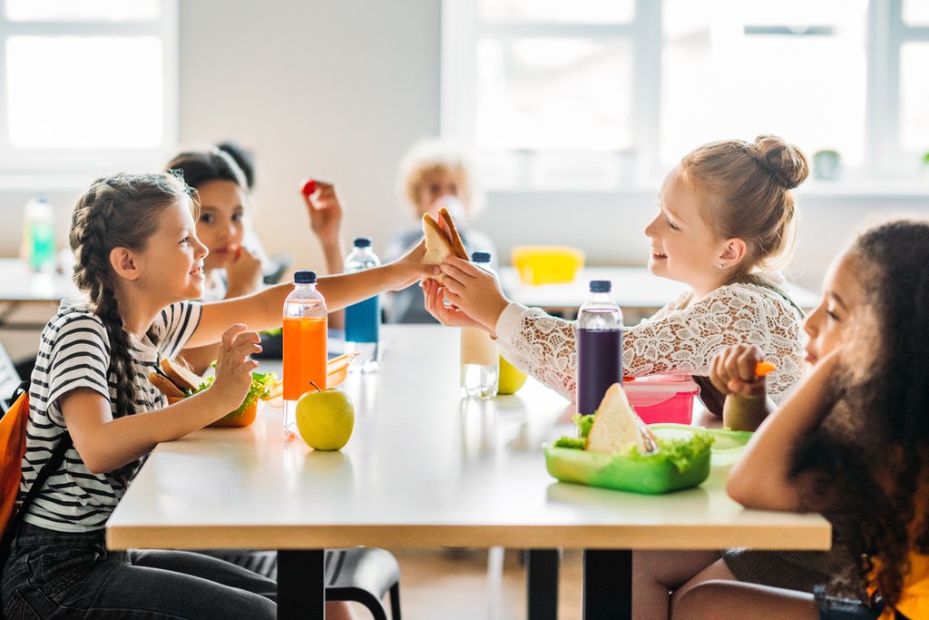 adorable-schoolgirls-taking-lunch-at-school-cafete-2023-11-27-05-27-48-utc-2